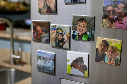 Fridge with family photos attached as magnets in a kitchen setting